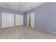 Bedroom with light purple walls and carpet flooring at 41405 W Cielo Ln, Maricopa, AZ 85138