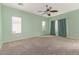 Spacious bedroom with ceiling fan and neutral carpeting at 41405 W Cielo Ln, Maricopa, AZ 85138