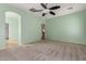 Bright bedroom with ceiling fan and access to upper level at 41405 W Cielo Ln, Maricopa, AZ 85138