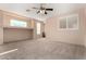 Spacious bedroom with ceiling fan and window shutters at 41405 W Cielo Ln, Maricopa, AZ 85138