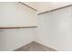 Spacious closet with wood shelving and hanging rods at 41405 W Cielo Ln, Maricopa, AZ 85138
