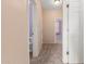 Hallway with carpet and doors to bedrooms and bathroom at 41405 W Cielo Ln, Maricopa, AZ 85138
