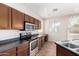 Kitchen with stainless steel appliances and wood cabinets at 41405 W Cielo Ln, Maricopa, AZ 85138