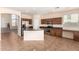 Open kitchen boasts stainless steel appliances and an island at 41405 W Cielo Ln, Maricopa, AZ 85138