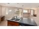 Island kitchen features a double sink and views to the backyard at 41405 W Cielo Ln, Maricopa, AZ 85138
