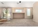 Living room with sliding door to backyard access at 41405 W Cielo Ln, Maricopa, AZ 85138