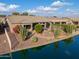 Single-story home on lakefront lot with lush desert landscaping at 42413 W Abbey Rd, Maricopa, AZ 85138