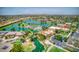 Aerial view of community with lake, pool, and clubhouse at 42413 W Abbey Rd, Maricopa, AZ 85138