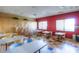 Art studio with tables, chairs, easels, and storage cabinets at 42413 W Abbey Rd, Maricopa, AZ 85138