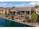 Backyard oasis with lake access, cactus, and patio at 42413 W Abbey Rd, Maricopa, AZ 85138
