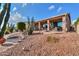 Landscaped backyard oasis with a walkway and cacti at 42413 W Abbey Rd, Maricopa, AZ 85138