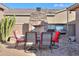Outdoor patio with fireplace, grill, and seating area at 42413 W Abbey Rd, Maricopa, AZ 85138