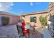 Relaxing backyard patio with seating and a stone fireplace at 42413 W Abbey Rd, Maricopa, AZ 85138