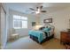 Charming bedroom with large window and ceiling fan at 42413 W Abbey Rd, Maricopa, AZ 85138
