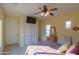 Bright bedroom with double doors and ceiling fan at 42413 W Abbey Rd, Maricopa, AZ 85138