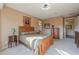 Spacious bedroom with wood furniture and access to a private patio at 42413 W Abbey Rd, Maricopa, AZ 85138