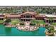 Community clubhouse with patio and fire pit near lake at 42413 W Abbey Rd, Maricopa, AZ 85138