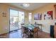 Bright dining area with patio access and wood table at 42413 W Abbey Rd, Maricopa, AZ 85138