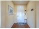 Bright entryway with tile floors and a solid wood door at 42413 W Abbey Rd, Maricopa, AZ 85138