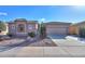 Single-story home with a two-car garage and desert landscaping at 42413 W Abbey Rd, Maricopa, AZ 85138