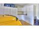Garage with cabinets, sink, and additional storage at 42413 W Abbey Rd, Maricopa, AZ 85138