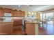 Kitchen with island, wood cabinets, and tile floors at 42413 W Abbey Rd, Maricopa, AZ 85138