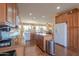 Open kitchen with island and stainless steel appliances at 42413 W Abbey Rd, Maricopa, AZ 85138