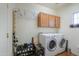 Laundry room with washer, dryer, and storage at 42413 W Abbey Rd, Maricopa, AZ 85138
