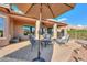 Covered patio with seating area and fire pit at 42413 W Abbey Rd, Maricopa, AZ 85138