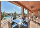 Covered patio overlooking a serene lake with seating at 42413 W Abbey Rd, Maricopa, AZ 85138