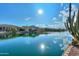 Calm lakefront view with clear reflections and a cactus at 42413 W Abbey Rd, Maricopa, AZ 85138