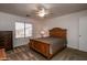 Bedroom with wood bed frame and ceiling fan at 4872 E Sandwick Dr, San Tan Valley, AZ 85140