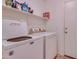 Bright laundry room with washer, dryer, and storage shelves at 4872 E Sandwick Dr, San Tan Valley, AZ 85140
