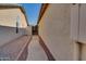 Sidewalk between house and fence leading to backyard access at 4872 E Sandwick Dr, San Tan Valley, AZ 85140