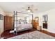 Main bedroom with king-size bed, ceiling fan, and hardwood floors at 500 E Encinas Ave, Gilbert, AZ 85234