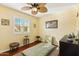 Bright bedroom with wood floors, a ceiling fan and window shutters at 500 E Encinas Ave, Gilbert, AZ 85234