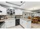 Bright kitchen features granite counters, white cabinets, and a breakfast nook at 500 E Encinas Ave, Gilbert, AZ 85234