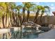 Inviting backyard pool with rock waterfall feature and lush landscaping at 500 E Encinas Ave, Gilbert, AZ 85234