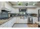 Well-equipped kitchen with white cabinets, granite countertops, and stainless steel sink at 5301 E Mitchell Dr, Phoenix, AZ 85018