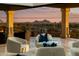 Balcony seating showcasing city views at sunset, complemented by stylish decor and neutral toned furniture at 5427 E Wonderview Rd, Phoenix, AZ 85018