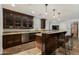 Well-equipped bar area with granite countertops, wood cabinetry, and bar seating, perfect for casual gatherings at 5427 E Wonderview Rd, Phoenix, AZ 85018