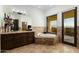 Elegant bathroom with a soaking tub, granite countertop vanity, and a window with scenic views, perfect for relaxation at 5427 E Wonderview Rd, Phoenix, AZ 85018