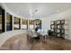 Elegant dining room features a glass table, white chairs, and modern lighting for a luxurious dining experience at 5427 E Wonderview Rd, Phoenix, AZ 85018