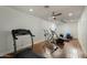 Bright home gym featuring hardwood floors and various exercise machines at 5427 E Wonderview Rd, Phoenix, AZ 85018