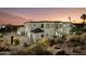 Beautiful multi-level home showcasing desert landscaping and a three-car garage at 5427 E Wonderview Rd, Phoenix, AZ 85018