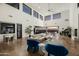 Open-concept living room with high ceilings, expansive windows, fireplace and modern furnishings at 5427 E Wonderview Rd, Phoenix, AZ 85018