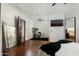 Comfortable bedroom with hardwood floors, ceiling fan, and connected office, ideal for a modern lifestyle at 5427 E Wonderview Rd, Phoenix, AZ 85018