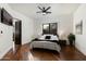 Serene main bedroom with hardwood floors, a large window, and a stylish ceiling fan, creating a cozy retreat at 5427 E Wonderview Rd, Phoenix, AZ 85018