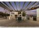 Outdoor kitchen with pizza oven and grill under a pergola with string lights at 5427 E Wonderview Rd, Phoenix, AZ 85018
