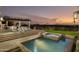Backyard pool and spa featuring outdoor dining area with a built in grill and views of the city at 5427 E Wonderview Rd, Phoenix, AZ 85018